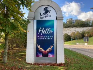 Outdoor sign of Bluewater shopping centre that says Hello and welcome to Bluewater