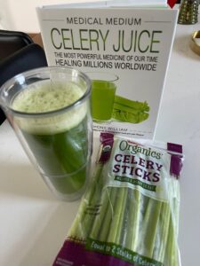 Celery juice detox with book, bag of celeries and juice 