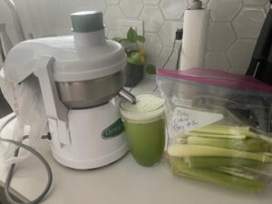 Juicer and bag of chopped celery to make celery juice