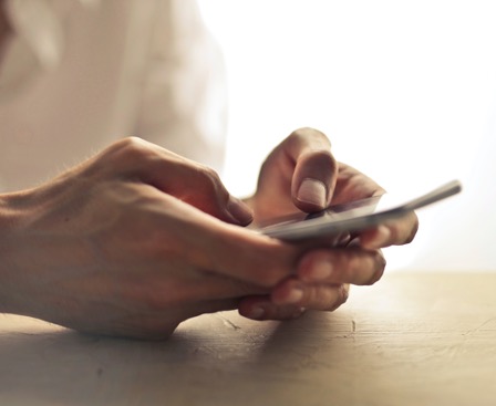 woman typing on phone