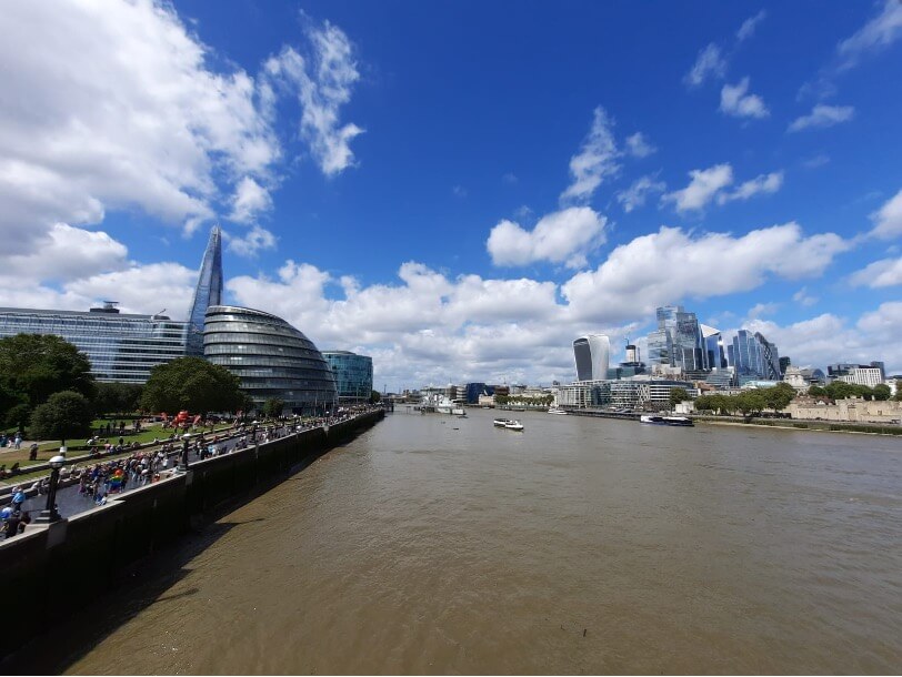 Views from Tower Bridge as one best free views of London – on left The Shard and the former London City Hall building. On right, commercial city skyscrapers including the Walkie Talkie building and The Gherkin